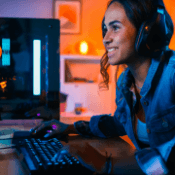 Woman playing with computer wearing headphones