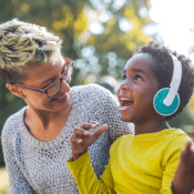 Woman with child wearing headphones