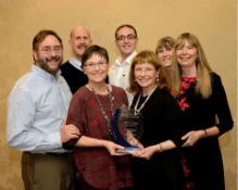 Team of people receiving award