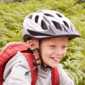 Kid riding bike wearing a  helmet